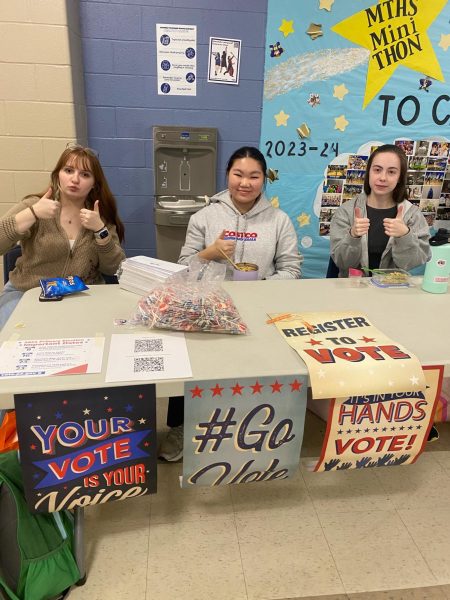 Anja Pelepko, My-Tam Huynh, and Katherine Riley (left to right) work the voting registration table.