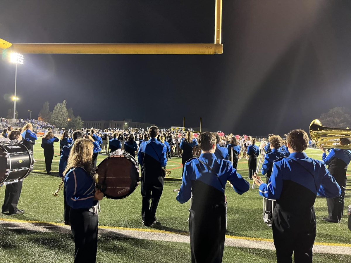 The marching band performs at a football game. Photo credit to Paul Gallelo.