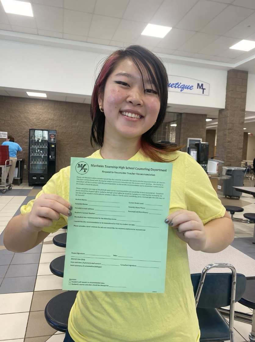 (Junior Link Crew member Alex Luu holding the teacher recommendation override form. Taken by Allure Cao).
