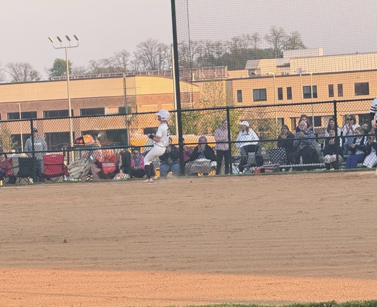 Junior Bella Stern making a sliding run to first base.